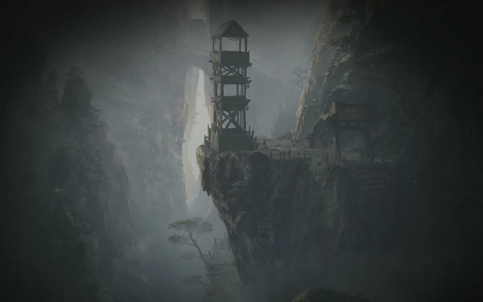 A tall wooden tower standing on a cliff in the fog